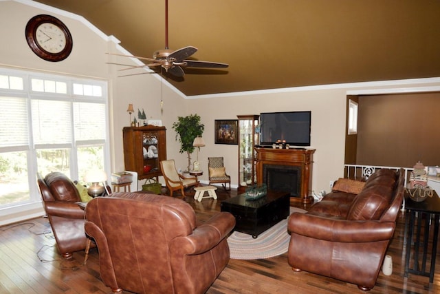 living room featuring hardwood / wood-style flooring, ceiling fan, lofted ceiling, and crown molding