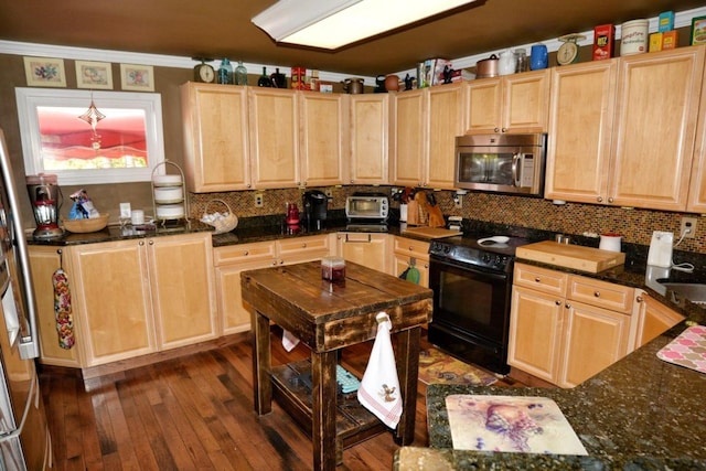 kitchen featuring light brown cabinets, stainless steel appliances, dark hardwood / wood-style floors, dark stone countertops, and crown molding