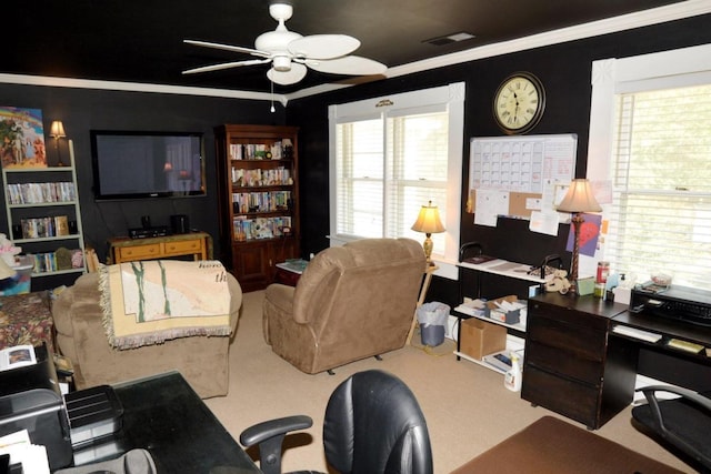 carpeted living room with ceiling fan, a healthy amount of sunlight, and ornamental molding