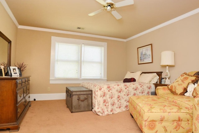 carpeted bedroom with ceiling fan and ornamental molding