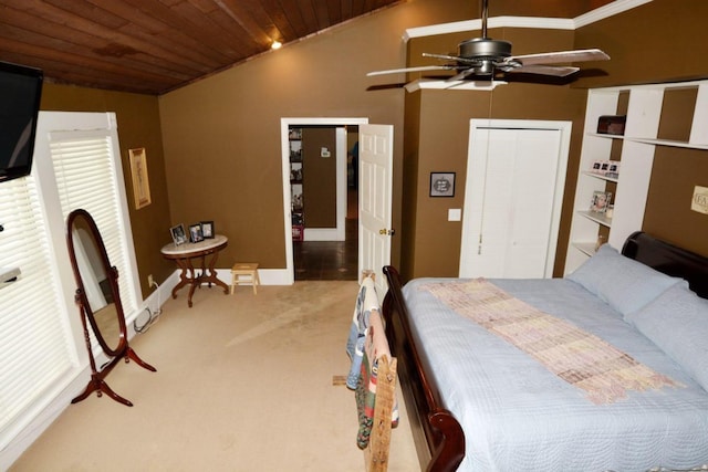 carpeted bedroom featuring wooden ceiling, lofted ceiling, crown molding, ceiling fan, and a closet