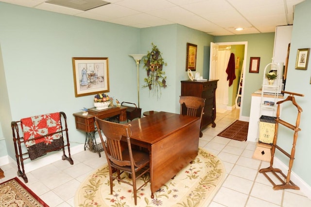 home office featuring a drop ceiling and light tile patterned floors