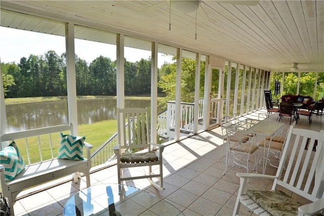 sunroom / solarium with a water view and wood ceiling