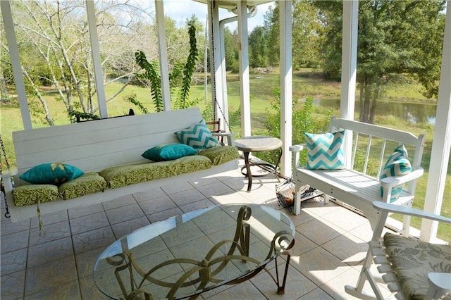 sunroom with a water view and a wealth of natural light