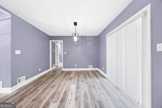 unfurnished dining area featuring hardwood / wood-style flooring