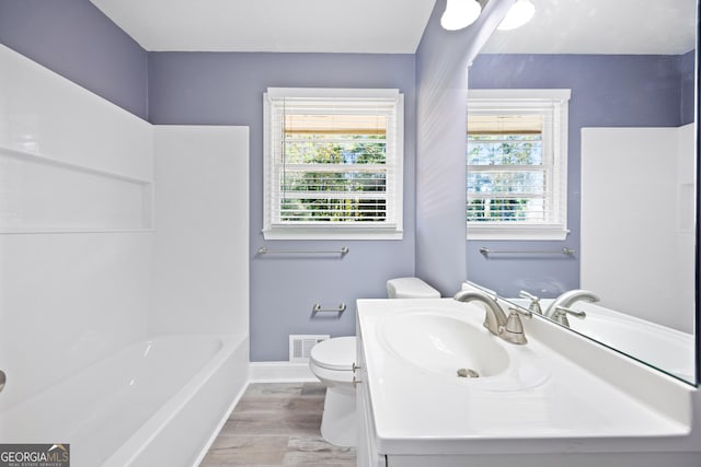 bathroom featuring hardwood / wood-style floors, vanity, and toilet