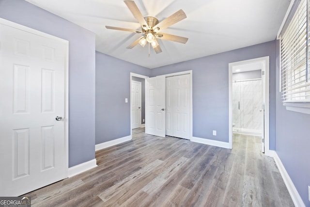 unfurnished bedroom with light wood-type flooring, ensuite bath, and ceiling fan