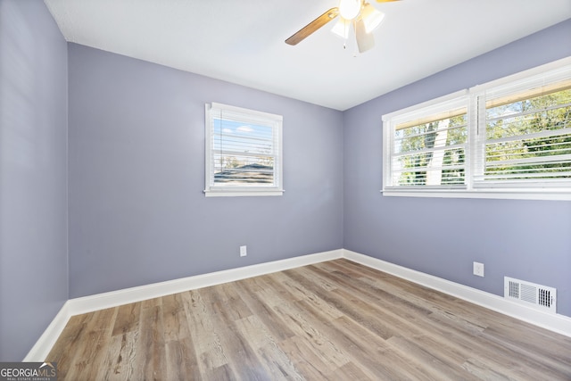 empty room featuring ceiling fan and light hardwood / wood-style floors