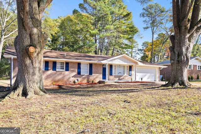 ranch-style home with covered porch and a garage