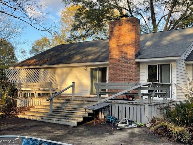 rear view of house featuring a deck