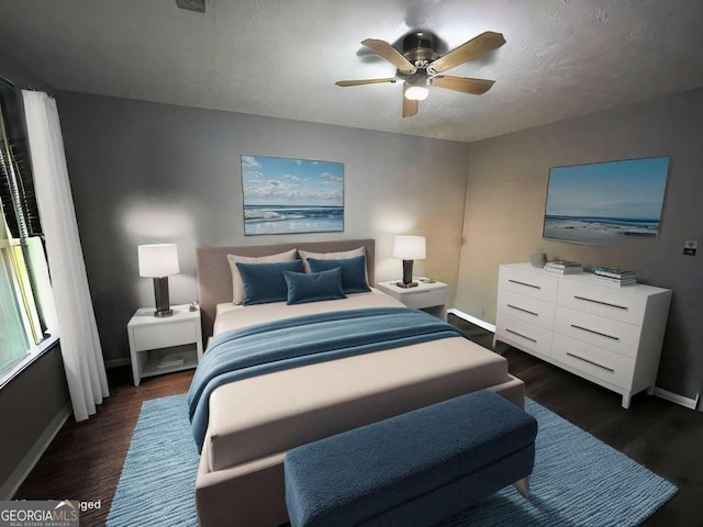 bedroom featuring ceiling fan, dark wood-type flooring, and a textured ceiling