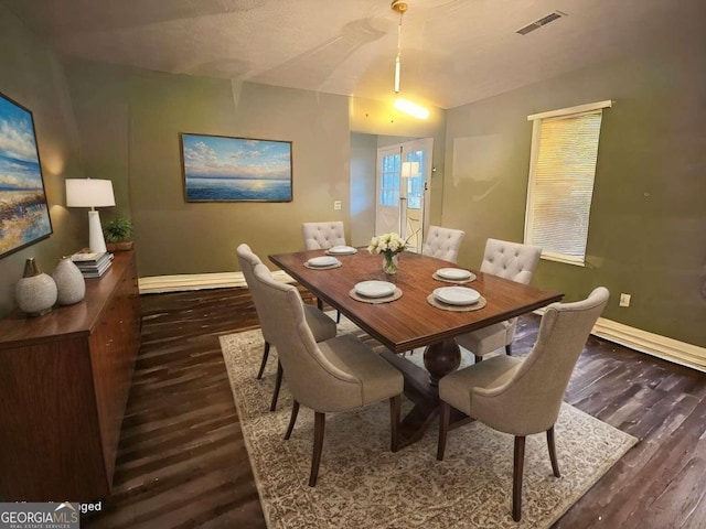 dining space featuring dark hardwood / wood-style floors