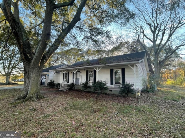 ranch-style home featuring covered porch and central air condition unit