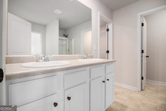 bathroom featuring vanity and an enclosed shower