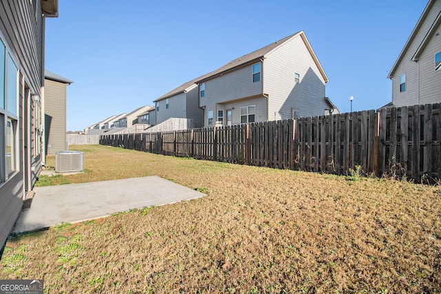 view of yard with central AC and a patio