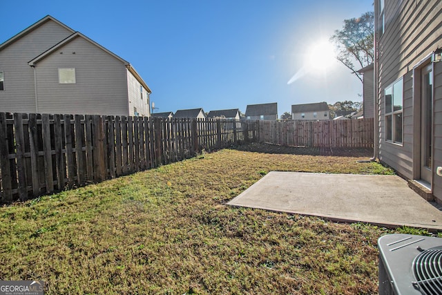 view of yard with central air condition unit and a patio area