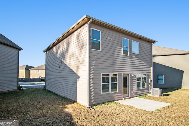 back of property featuring a lawn, cooling unit, and a patio area