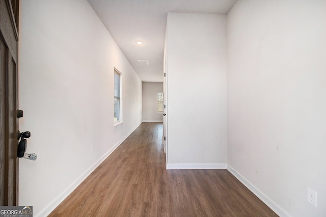 corridor with dark wood-type flooring