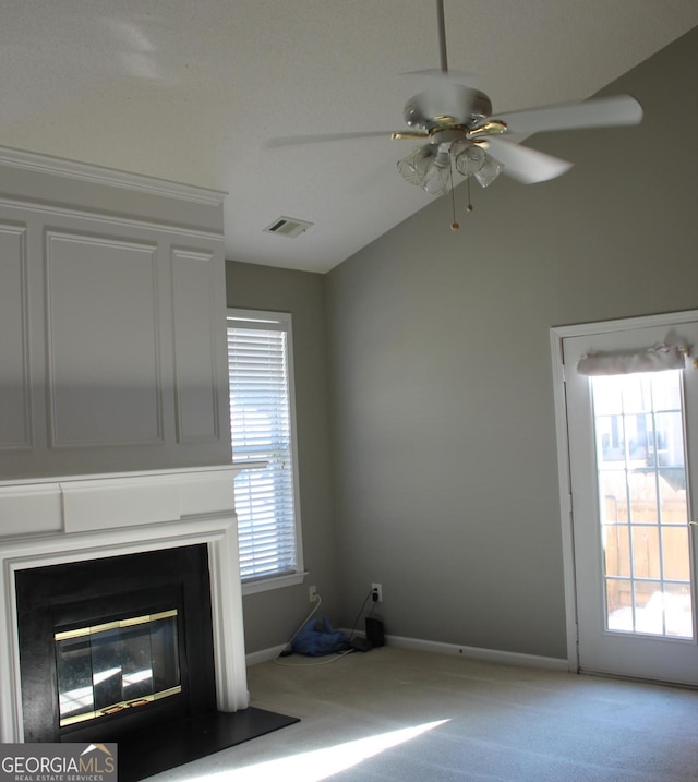 unfurnished living room with ceiling fan, carpet, and vaulted ceiling