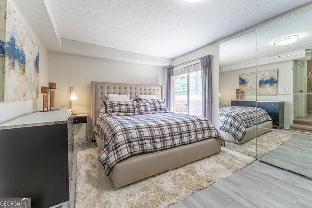 111 Swanton Hill Ct, Decatur, GA 30030 - bedroom with a textured ceiling and wood finished floors