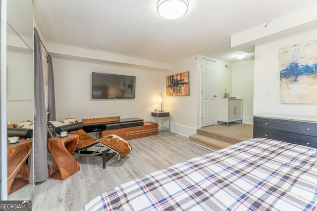 111 Swanton Hill Ct, Decatur, GA 30030 - bedroom with wood finished floors, baseboards, and a textured ceiling