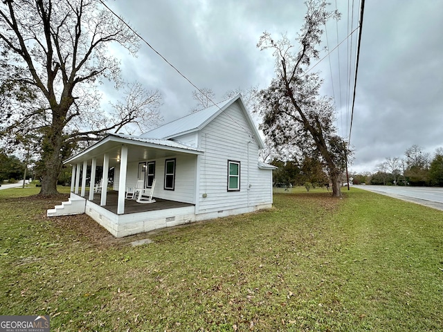 view of property exterior with a lawn and covered porch