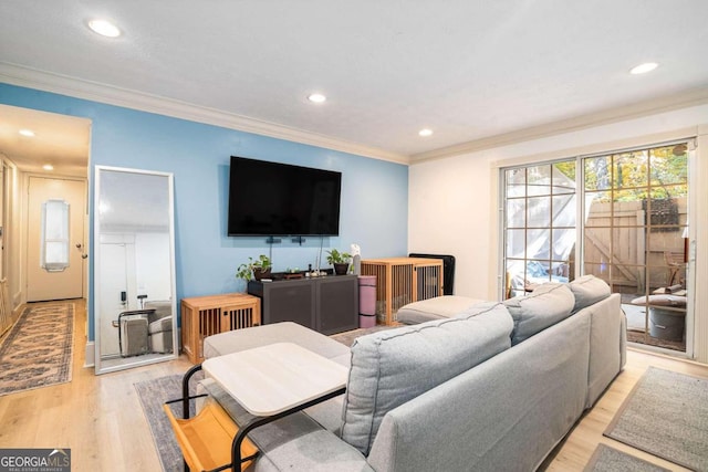 living room with ornamental molding and light wood-type flooring