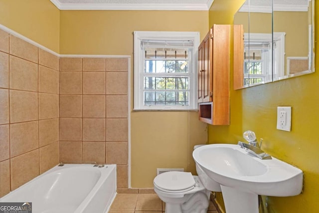 bathroom featuring toilet, crown molding, tile patterned flooring, and a washtub