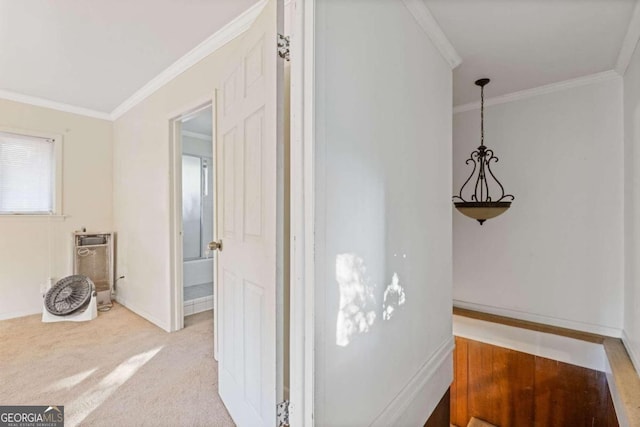 corridor featuring heating unit, light carpet, and ornamental molding