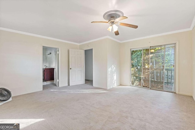 carpeted spare room with ceiling fan and ornamental molding