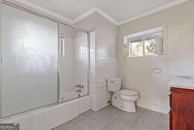 full bathroom with combined bath / shower with glass door, vanity, toilet, and ornamental molding