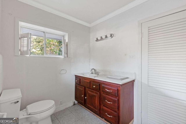 bathroom featuring toilet, vanity, tile patterned floors, and crown molding