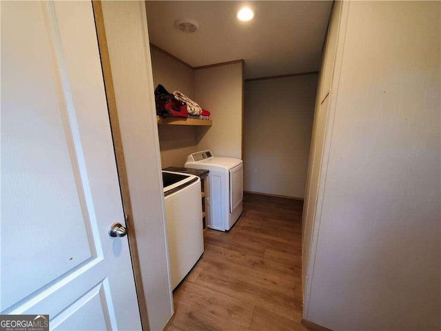 laundry room with separate washer and dryer and light wood-type flooring