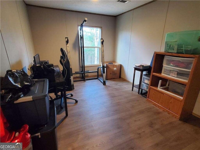 office with hardwood / wood-style floors and a textured ceiling