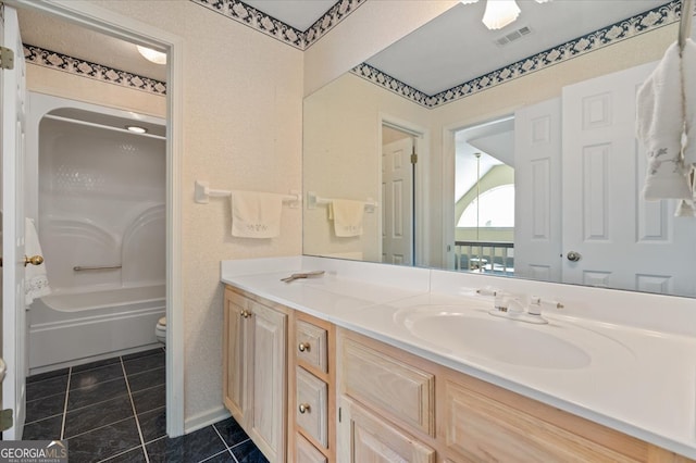 full bathroom with tile patterned floors, vanity,  shower combination, and toilet