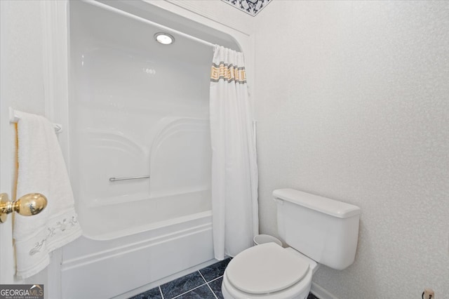 bathroom with shower / bath combo with shower curtain, tile patterned flooring, and toilet