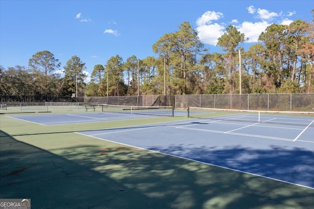 view of tennis court with basketball hoop