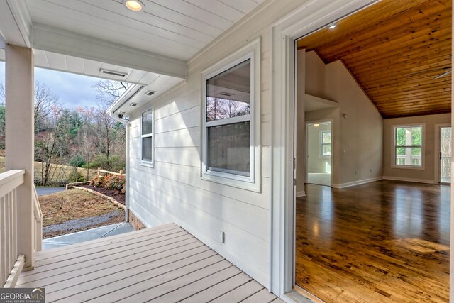 kitchen featuring white cabinets, sink, vaulted ceiling, appliances with stainless steel finishes, and wood ceiling