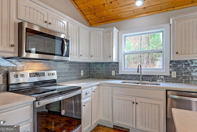 4502 Ramsay Dr, Hiawassee, GA 30546 - kitchen featuring stainless steel appliances, a sink, wooden ceiling, vaulted ceiling, and light countertops