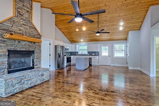 unfurnished living room with a fireplace, dark hardwood / wood-style flooring, high vaulted ceiling, and wood ceiling