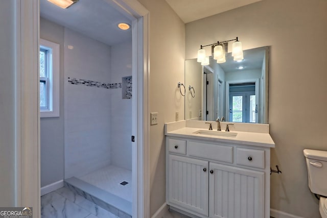4502 Ramsay Dr, Hiawassee, GA 30546 - full bathroom featuring toilet, vanity, a tile shower, marble finish floors, and baseboards