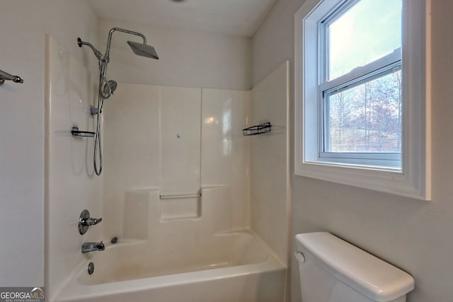 bathroom with bathing tub / shower combination and toilet