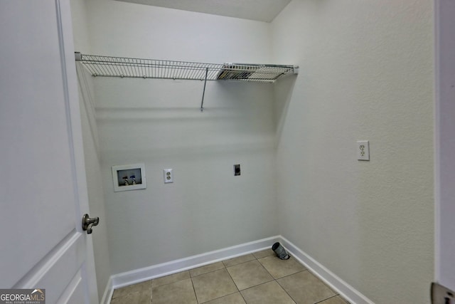 laundry area with electric dryer hookup, hookup for a washing machine, and light tile patterned flooring