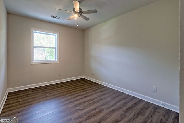 spare room featuring ceiling fan and dark wood-type flooring