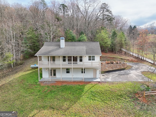4502 Ramsay Dr, Hiawassee, GA 30546 - back of property with a patio area, a lawn, a chimney, a shingled roof, and a wooden deck