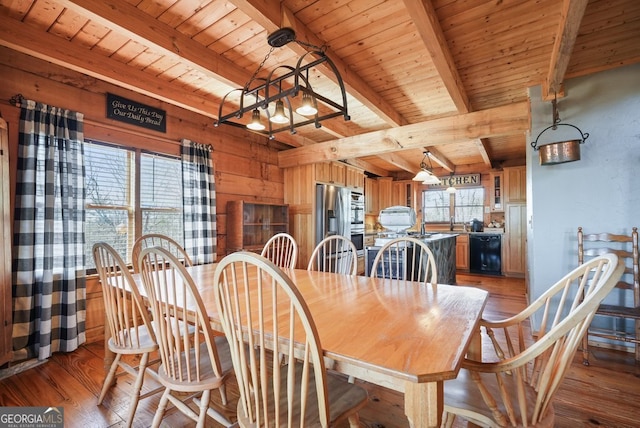 dining room featuring wood ceiling, wood walls, light wood-style flooring, and beamed ceiling