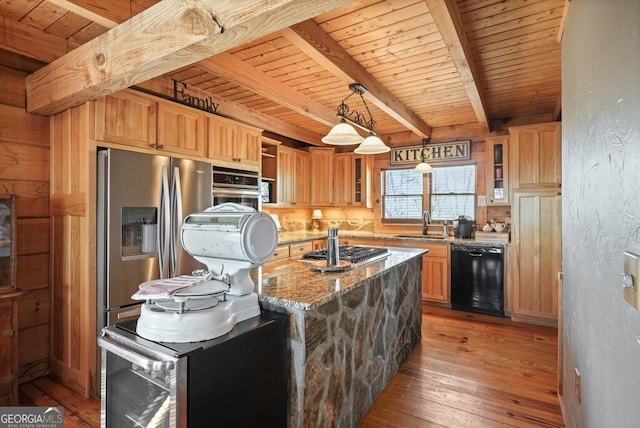 kitchen featuring wood finished floors, appliances with stainless steel finishes, light stone countertops, beamed ceiling, and glass insert cabinets