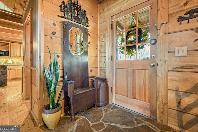 interior space featuring dark hardwood / wood-style floors and wood walls