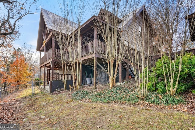 exterior space with stairway, a gate, fence, and a wooden deck