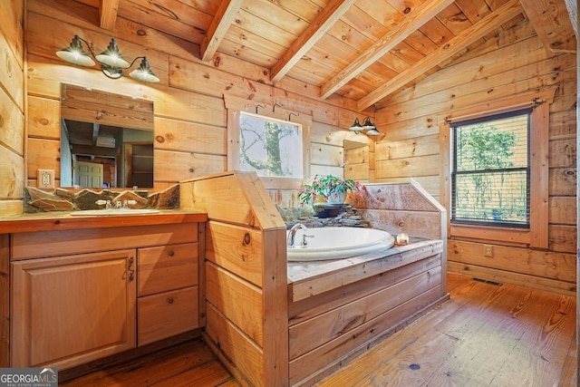 bathroom with hardwood / wood-style floors, a wealth of natural light, wooden walls, and wood ceiling